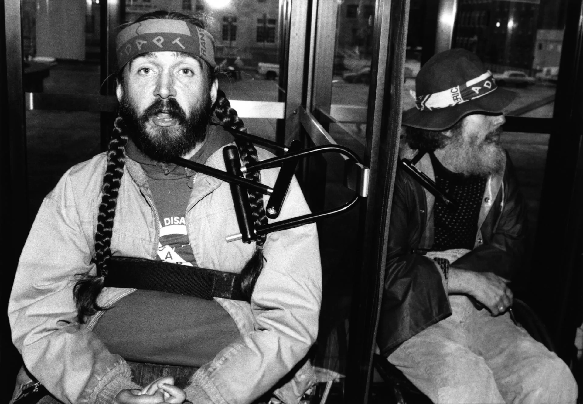 ADAPT in Los Angeles, Mike Auberger and Bob Kafka chained by the neck to a revolving door.