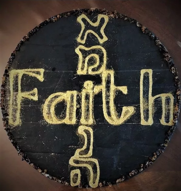 Black background with the word “Faith” printed in capital letters in English from left to right and in Hebrew letters from top to bottom, outlined in gold glitter, and outer edges outlined in mosaic tile fragments.