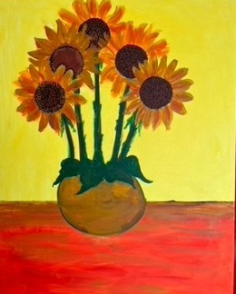 Sunflowers are arranged in a pot on red flooring with a saturated yellow background.